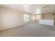 Large living room with carpet, neutral walls, and multiple windows for natural light at 22196 W Tonto St, Buckeye, AZ 85326