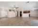 Open-concept living room showcases tile flooring, with smooth transition to kitchen and staircase visible nearby at 22196 W Tonto St, Buckeye, AZ 85326