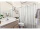 Bathroom with decorative wallpaper border and shower with striped curtain at 23756 S Vacation Way, Sun Lakes, AZ 85248