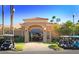 Charming clubhouse with a red tile roof, beautiful landscaping, and convenient golf cart parking at 23756 S Vacation Way, Sun Lakes, AZ 85248