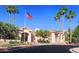 Beautifully designed community clubhouse with palm trees, an American flag, and manicured landscaping at 23756 S Vacation Way, Sun Lakes, AZ 85248