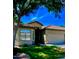Charming single-story home boasts a tile roof, two-car garage and well-maintained front yard at 23756 S Vacation Way, Sun Lakes, AZ 85248