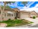 Attractive single-story home with a well-kept lawn, mature trees, tiled roof, and an attached two-car garage at 23756 S Vacation Way, Sun Lakes, AZ 85248