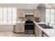 Well-lit kitchen with white countertops, ample cabinet space, stainless steel appliances, and a double sink at 23756 S Vacation Way, Sun Lakes, AZ 85248