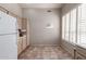 Eat-in kitchen with ample cabinet storage, tiled floors, and natural light from a large window at 23756 S Vacation Way, Sun Lakes, AZ 85248
