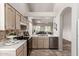 Bright and airy kitchen with stainless appliances, views into the living room, and abundant cabinet space at 23756 S Vacation Way, Sun Lakes, AZ 85248