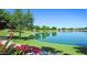 Scenic lake view with lush landscaping, perfect for relaxing and enjoying the natural surroundings at 23756 S Vacation Way, Sun Lakes, AZ 85248