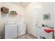 Functional laundry room with washer, dryer, and utility sink at 23756 S Vacation Way, Sun Lakes, AZ 85248