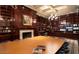 Elegant library with floor-to-ceiling bookshelves, a grand conference table, and sophisticated lighting at 23756 S Vacation Way, Sun Lakes, AZ 85248