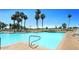 Resort-style community swimming pool with lounge chairs, palm trees and meticulously kept grounds at 23756 S Vacation Way, Sun Lakes, AZ 85248