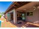 Cozy covered patio offering seamless indoor-outdoor living with a fireplace and comfortable seating at 2402 E Cinnabar Ave, Phoenix, AZ 85028