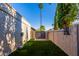 A fully fenced yard has easy backyard access with a small grass area, basketball hoop, and privacy at 2402 E Cinnabar Ave, Phoenix, AZ 85028