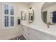 Bathroom features double sinks, quartz countertops, gold fixtures, and plantation shutters for natural light at 2402 E Cinnabar Ave, Phoenix, AZ 85028