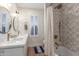 Stylish bathroom featuring double sinks, modern fixtures, and a beautifully tiled shower/tub combo at 2402 E Cinnabar Ave, Phoenix, AZ 85028