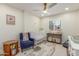 Bright Bedroom with a ceiling fan, modern furniture, and an animal themed rug at 2402 E Cinnabar Ave, Phoenix, AZ 85028