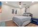 Cozy bedroom features a ceiling fan, wood-look floors, and a serene atmosphere for relaxation at 2402 E Cinnabar Ave, Phoenix, AZ 85028