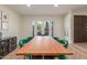 Bright dining area features a wood table, green chairs, and backyard access at 2402 E Cinnabar Ave, Phoenix, AZ 85028