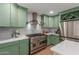 This stylish kitchen features custom cabinets, granite countertops, a professional range, and stainless appliances at 2402 E Cinnabar Ave, Phoenix, AZ 85028