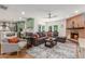 Open concept living area features a brick fireplace, a comfortable sofa, and backyard access at 2402 E Cinnabar Ave, Phoenix, AZ 85028