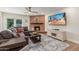 Cozy living room features a brick fireplace, comfortable seating, and backyard access at 2402 E Cinnabar Ave, Phoenix, AZ 85028