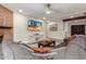 Bright living area features a brick fireplace, comfortable seating, and a modern television at 2402 E Cinnabar Ave, Phoenix, AZ 85028