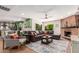 Open concept living area features a brick fireplace, a comfortable sofa, and backyard access at 2402 E Cinnabar Ave, Phoenix, AZ 85028