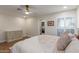 The main bedroom includes wood-look tile floors, a closet, and a ceiling fan at 2402 E Cinnabar Ave, Phoenix, AZ 85028