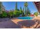 A refreshing pool is surrounded by lush landscaping, creating a tranquil oasis in this backyard setting at 2402 E Cinnabar Ave, Phoenix, AZ 85028