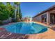 Beautiful backyard pool area with lush landscaping and lounge chairs for relaxation and enjoyment at 2402 E Cinnabar Ave, Phoenix, AZ 85028