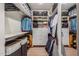 Spacious walk-in closet with custom shelving, drawers, and ample storage space at 2402 E Cinnabar Ave, Phoenix, AZ 85028