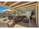 Outdoor patio with comfortable seating, a dining area, an outdoor TV, and a hot tub at 2422 W Acoma Dr, Phoenix, AZ 85023