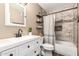Updated bathroom features a white vanity, modern fixtures, and a tiled shower/tub combo for a sleek design at 2422 W Acoma Dr, Phoenix, AZ 85023