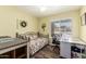 This bedroom is versatile and features hardwood floors, a ceiling fan, and a window for natural light at 2422 W Acoma Dr, Phoenix, AZ 85023
