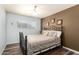 This cozy bedroom features a stylish bed frame, a ceiling fan, and a window for natural light and ventilation at 2422 W Acoma Dr, Phoenix, AZ 85023
