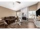 Comfortable living room featuring a brick fireplace, plush seating, and hardwood floors with lots of natural light at 2422 W Acoma Dr, Phoenix, AZ 85023