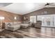Spacious living room featuring hardwood floors, a comfortable sectional, and modern decor at 2422 W Acoma Dr, Phoenix, AZ 85023