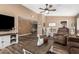 Spacious living room with wood-look floors, a ceiling fan, and a view into the dining area, perfect for gatherings at 2422 W Acoma Dr, Phoenix, AZ 85023