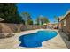 Beautiful backyard pool with a travertine deck and lush landscaping at 2422 W Acoma Dr, Phoenix, AZ 85023