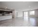 Bright, open-concept living room features a modern kitchen, tile floors, and access to the backyard through sliding glass doors at 2586 E Music Mountain Ave, Apache Junction, AZ 85119