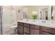 Bathroom with double sink vanity, a plant on the counter, and tile floors at 2631 S Sulley Dr # 104, Gilbert, AZ 85295