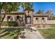 Charming clubhouse entrance with a stone tower, arched gate, and landscaped walkway in a serene community at 2631 S Sulley Dr # 104, Gilbert, AZ 85295