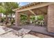 Outdoor gazebo with stone pillars providing shade for grilling and picnic tables in a tranquil community setting at 2631 S Sulley Dr # 104, Gilbert, AZ 85295