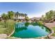 A tranquil community pond featuring a fountain and lush greenery, creating a peaceful atmosphere at 2631 S Sulley Dr # 104, Gilbert, AZ 85295
