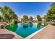 Scenic community pond with a fountain and lush landscaping, creating a serene environment at 2631 S Sulley Dr # 104, Gilbert, AZ 85295