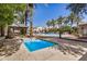 Inviting community with a hot tub and pool surrounded by palm trees and shaded seating areas at 2631 S Sulley Dr # 104, Gilbert, AZ 85295