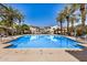 Beautiful community pool view flanked by palm trees, gazebos and lounge seating for relaxing enjoyment at 2631 S Sulley Dr # 104, Gilbert, AZ 85295