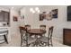 Cozy dining area with a round table, decorative chandelier, and stylish wall art at 2631 S Sulley Dr # 104, Gilbert, AZ 85295