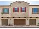 Charming townhome exterior with well-maintained garages and colorful shutters, offering inviting curb appeal at 2631 S Sulley Dr # 104, Gilbert, AZ 85295
