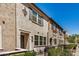 Attractive townhome exteriors with lush green landscaping and colorful shutters on a sunny day at 2631 S Sulley Dr # 104, Gilbert, AZ 85295