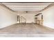 Spacious garage with ample room for parking and storage, featuring a workbench and overhead racks at 2631 S Sulley Dr # 104, Gilbert, AZ 85295